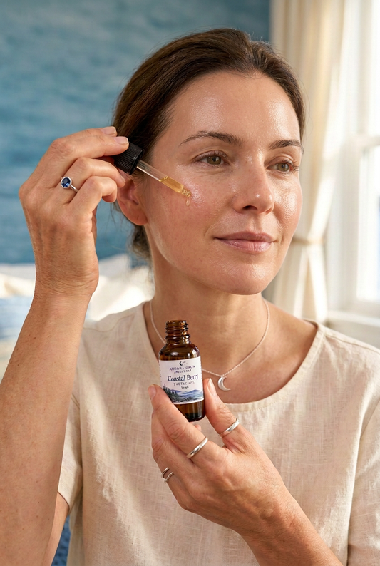 Younger woman with luminous glowing skin applying Coastal Berry facial oil